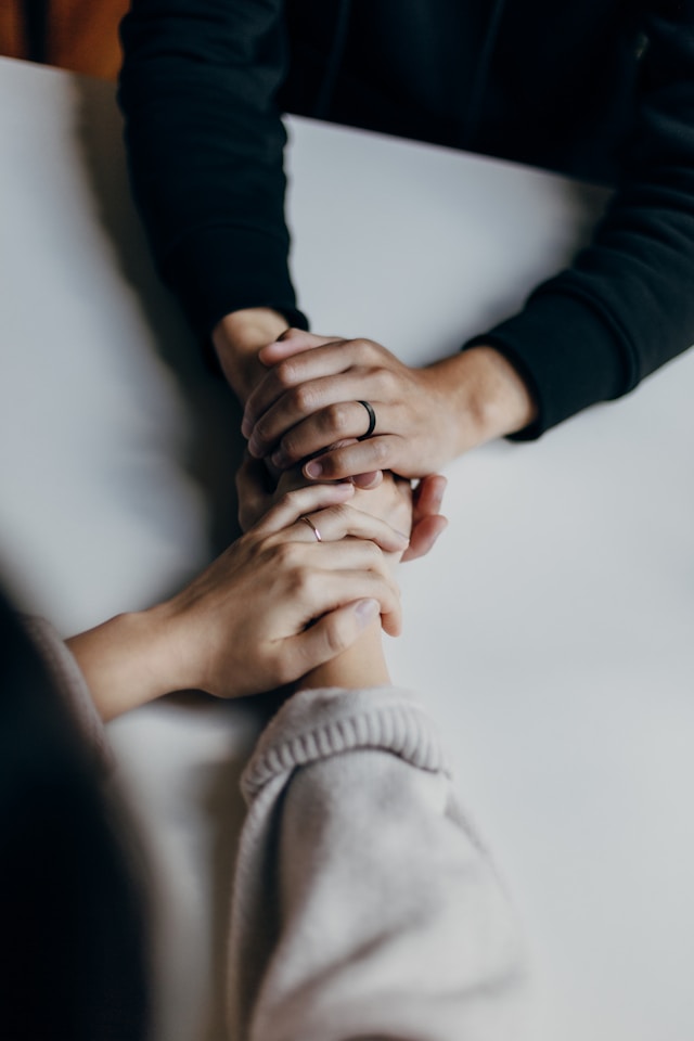 Deux mains posées l'une sur l'autre, symbole de soutien psychologique